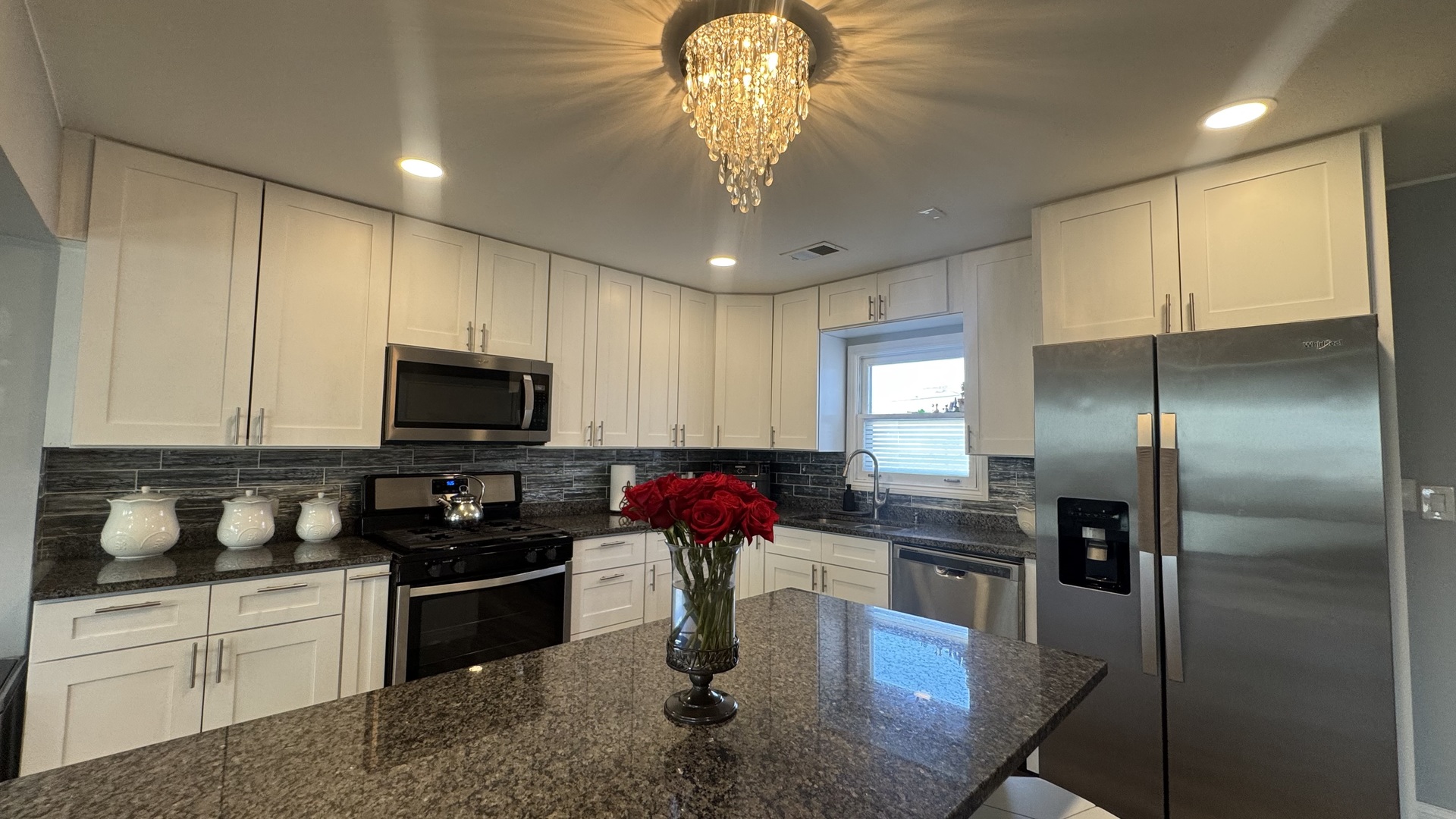 7700 West 83rd Street Bridgeview, IL 60455 - Photo 12 of 37 a kitchen with stainless steel appliances granite countertop a sink refrigerator stove and microwave