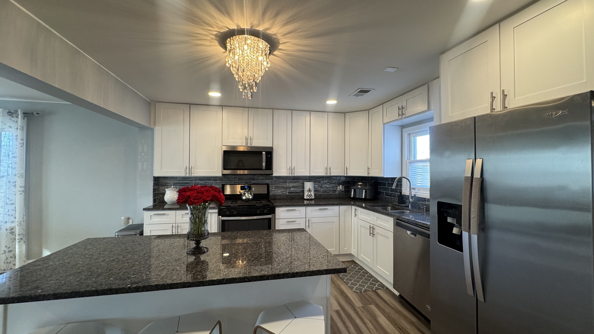 7700 West 83rd Street Bridgeview, IL 60455 - Photo 14 of 37 a kitchen with kitchen island granite countertop a sink stainless steel appliances and cabinets