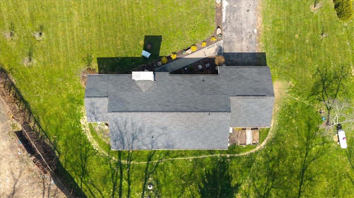 9555 Clyo Road Dayton, OH 45458 - Photo 27 of 31 An aerial perspective reveals a home with a well-maintained roof amidst lush green surroundings.