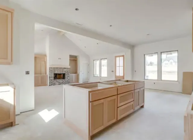a large white kitchen with cabinets and a sink