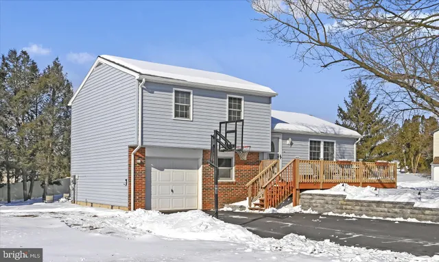 a view of a house with snow on the road