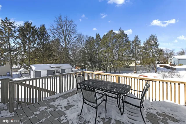 a view of a chair and table on the deck
