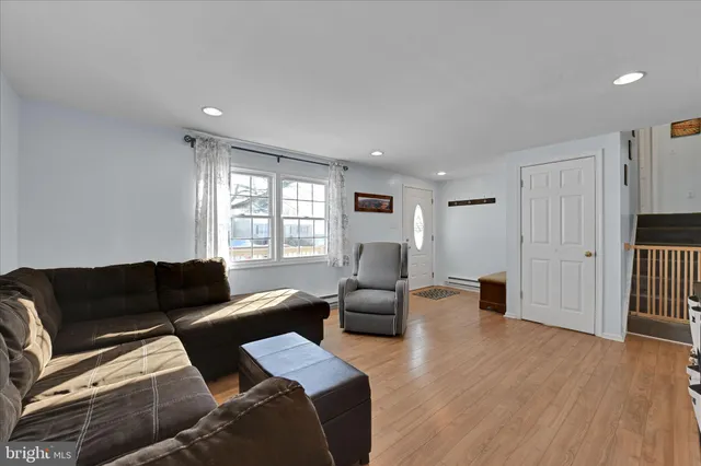 a living room with furniture window and wooden floor