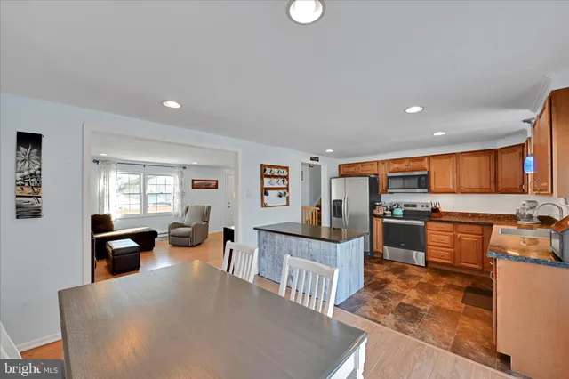 a large white kitchen with stainless steel appliances