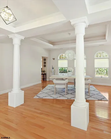 a kitchen with stainless steel appliances kitchen island granite countertop a stove a sink a dining table and chairs