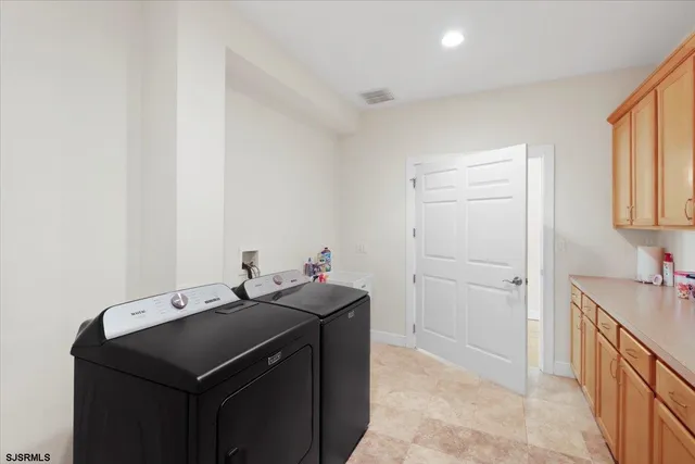 a living room with furniture kitchen view and a large window