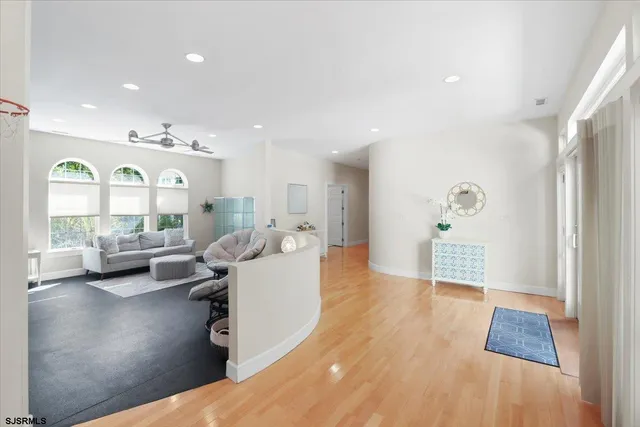 a view of a kitchen island a chandelier and living room view