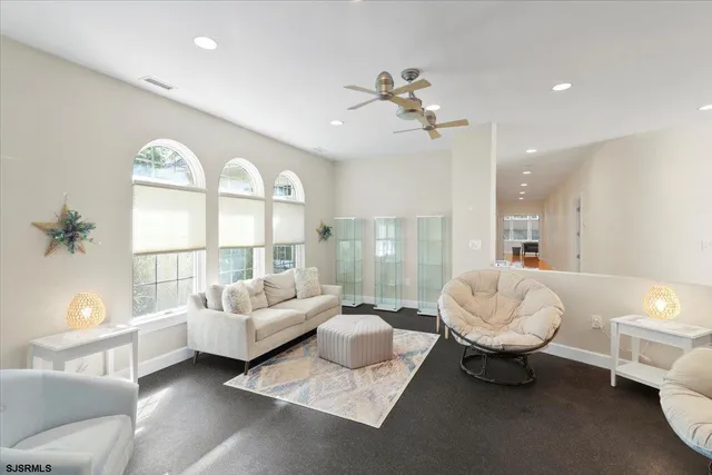 a spacious bedroom with a bed and a dresser with wooden floor