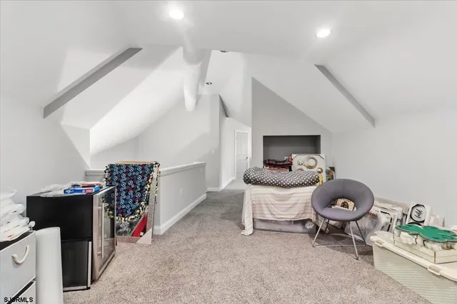 a view of a house with a small yard and large trees