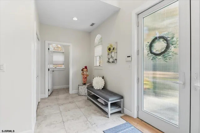 a room with painting and a glass door