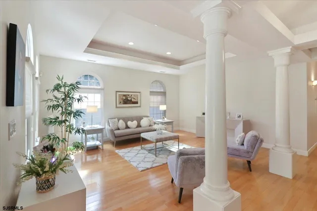 a living room with fireplace furniture and a large window
