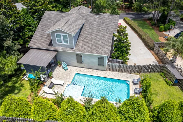 an aerial view of a house with swimming pool garden and patio