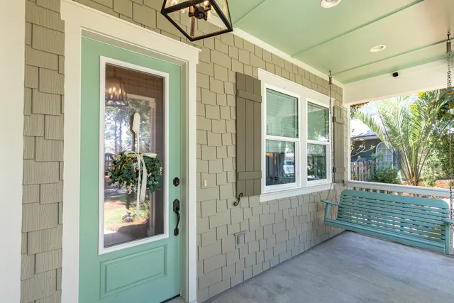 a kitchen with stainless steel appliances a refrigerator a stove a sink and chairs