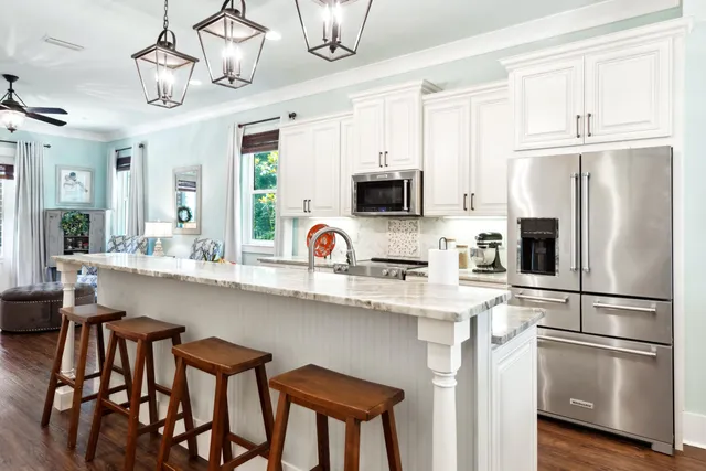 a kitchen with stainless steel appliances granite countertop a refrigerator and a stove