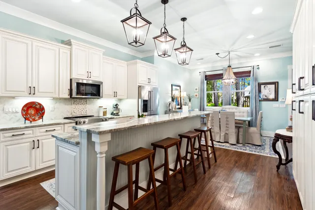 a view of a dining room with furniture and chandelier