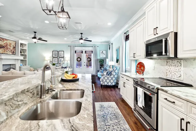 a kitchen with stainless steel appliances granite countertop a stove a sink and a refrigerator