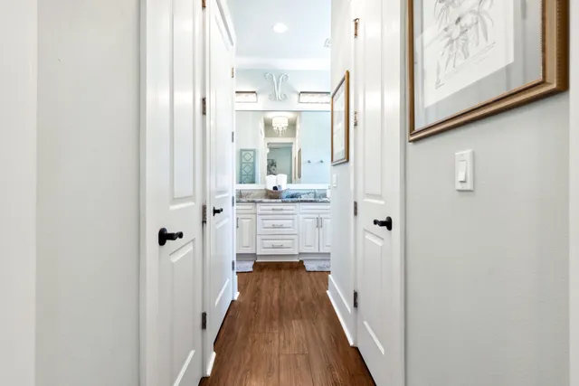 a bathroom with a granite countertop sink mirror and cabinets
