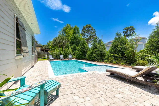 a view of house with backyard outdoor seating and green space