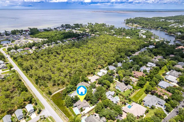 a view of a patio with a table and chairs under an umbrella