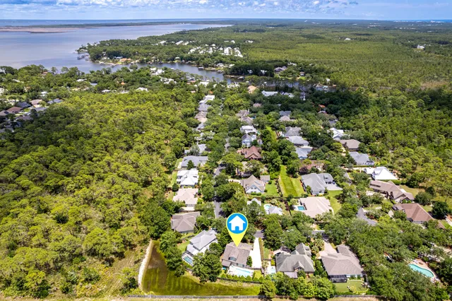 a view of a patio with chairs next to a yard