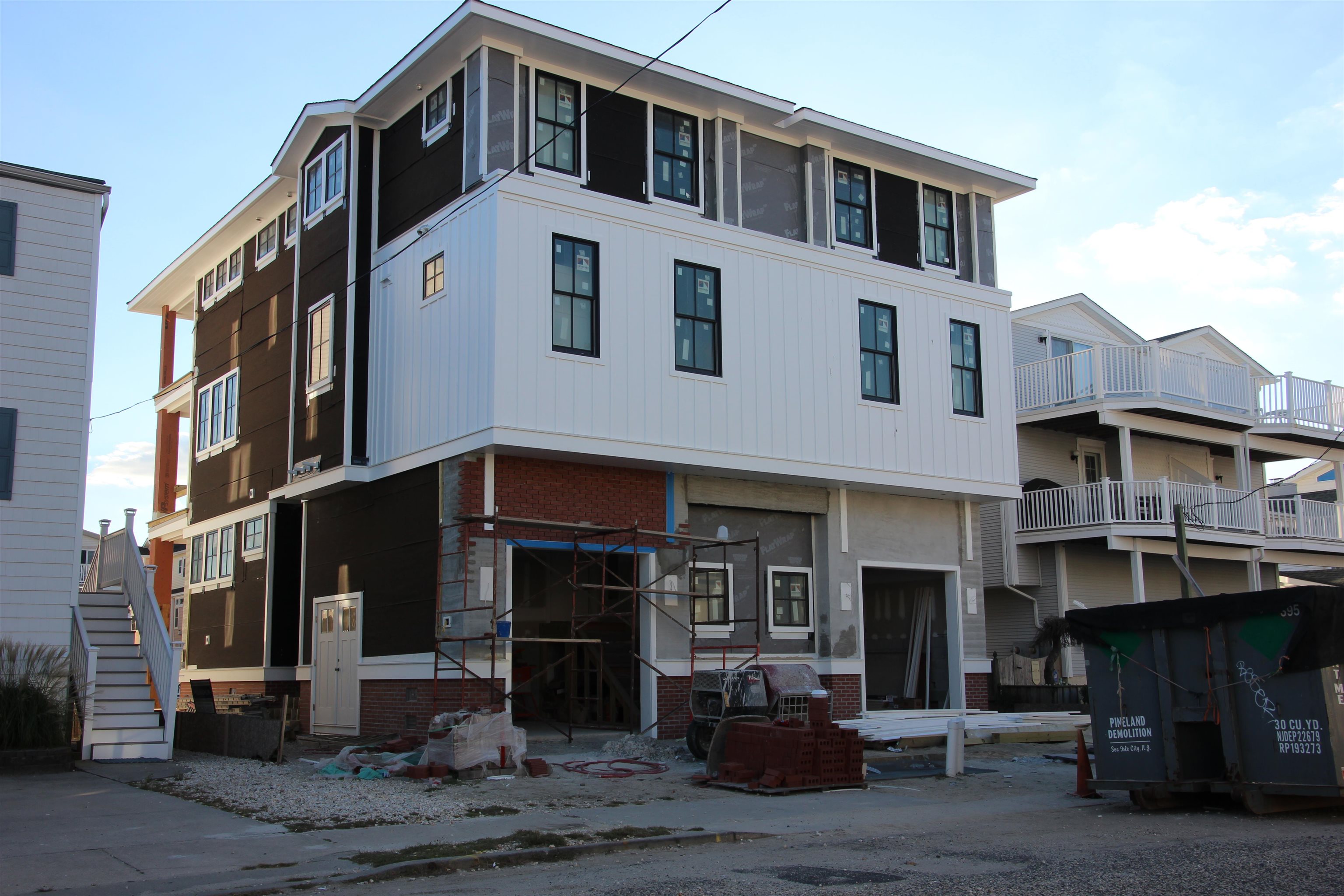 330 46th Place, Unit EAST Sea Isle City, NJ 08243 - Photo 2 of 3 a front view of a building with glass windows