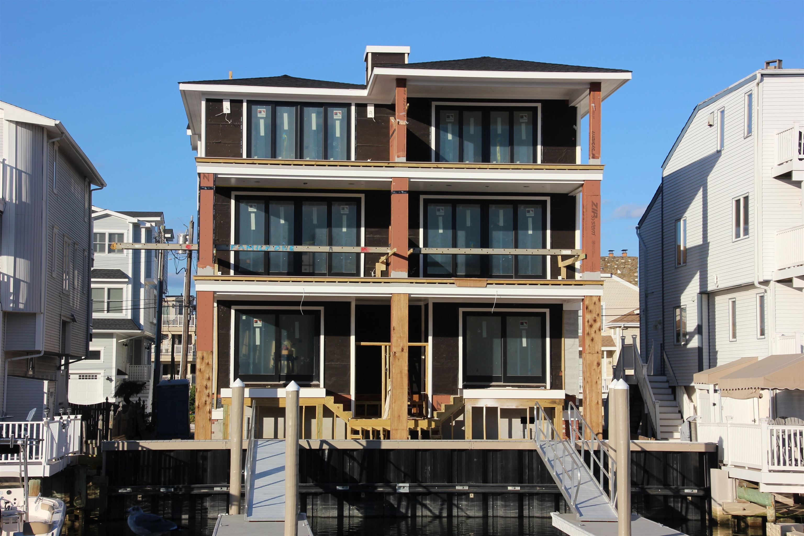 330 46th Place, Unit EAST Sea Isle City, NJ 08243 - Photo 3 of 3 a front view of large building with large windows