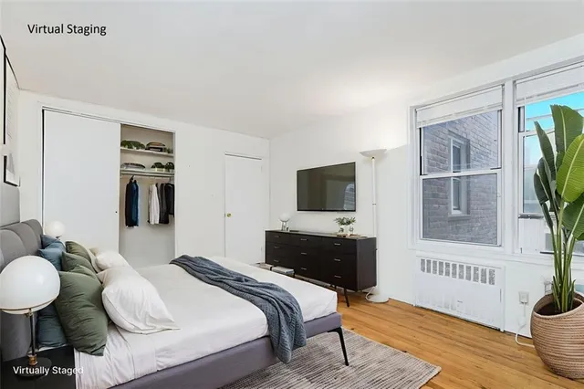 a view of empty room with wooden floor and windows