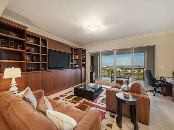 a living room with furniture lamp and window