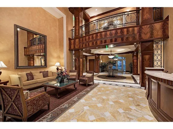 a living room with furniture a clock and a large window