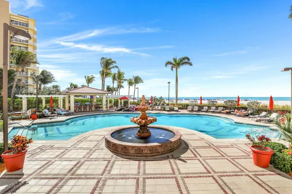 a view of a swimming pool with an outdoor space and seating area
