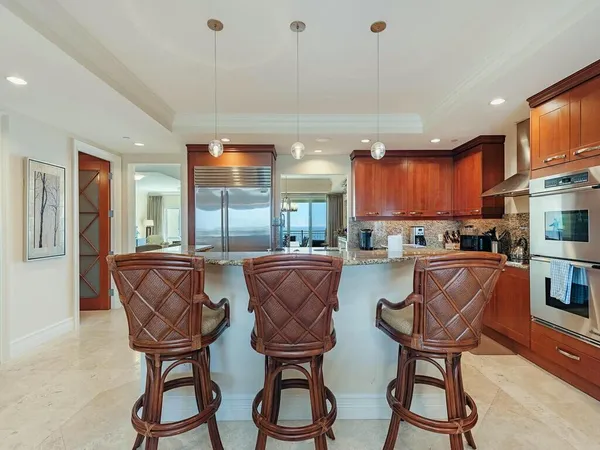 a view of kitchen with dining table and chairs