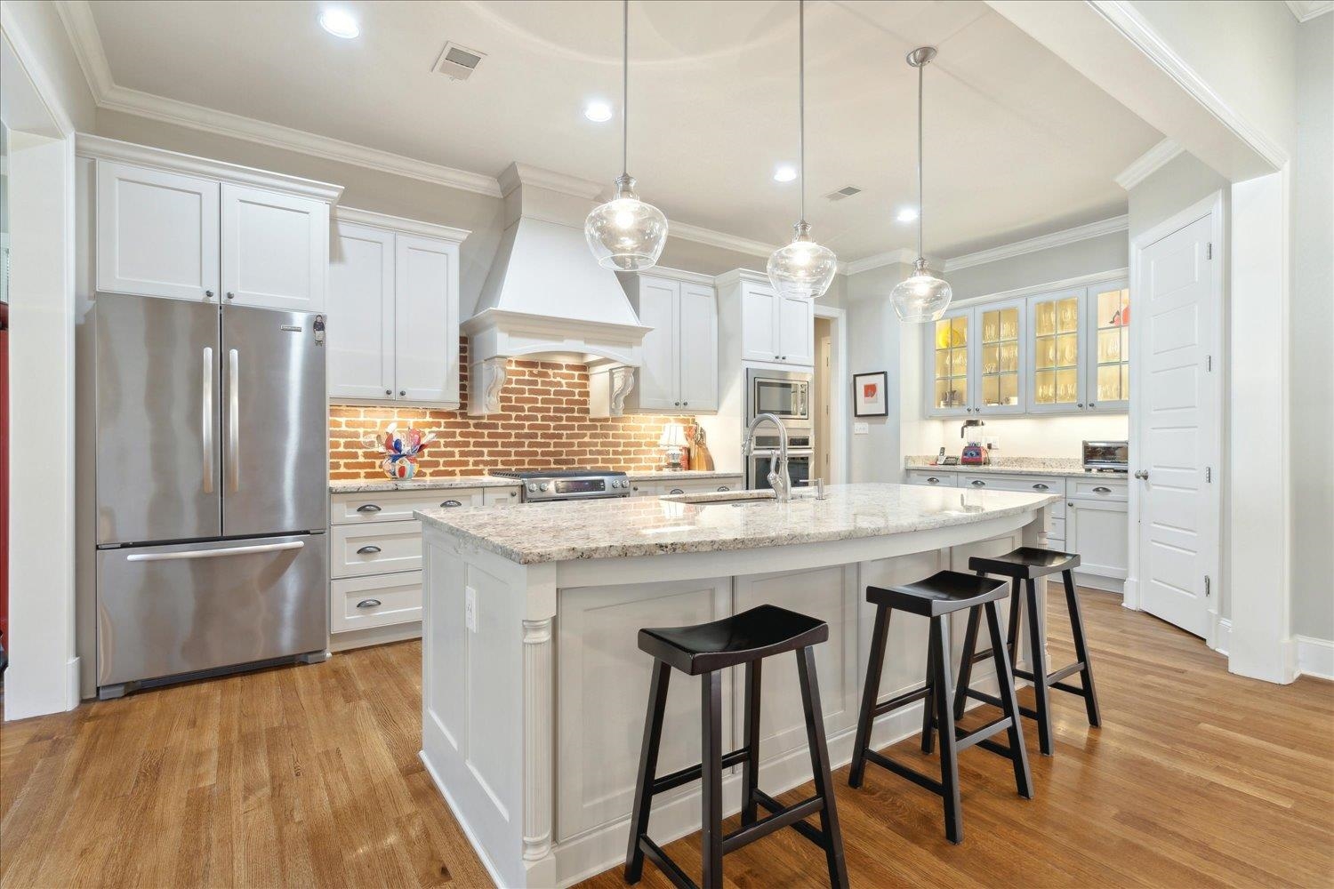 5140 Shady Grove Road Memphis, TN 38117 - Photo 12 of 39 a kitchen with stainless steel appliances granite countertop a refrigerator a sink dishwasher a stove and white countertops with wooden floor