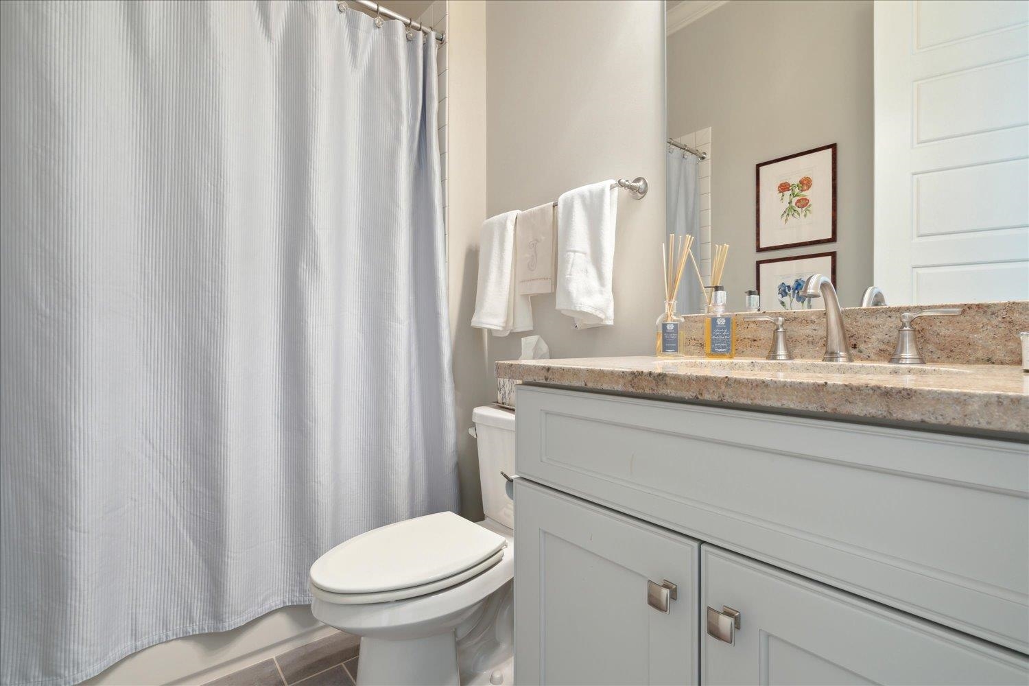 5140 Shady Grove Road Memphis, TN 38117 - Photo 25 of 39 a bathroom with a granite countertop sink and a toilet