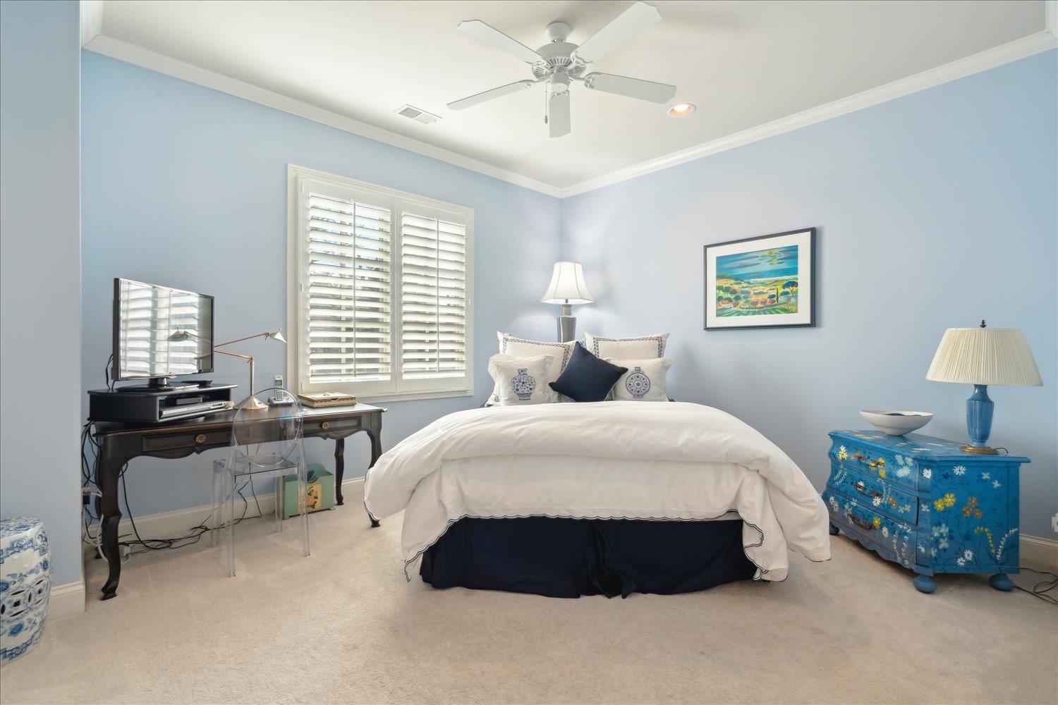 5140 Shady Grove Road Memphis, TN 38117 - Photo 30 of 39 a spacious bedroom with a bed a couch and a chandelier