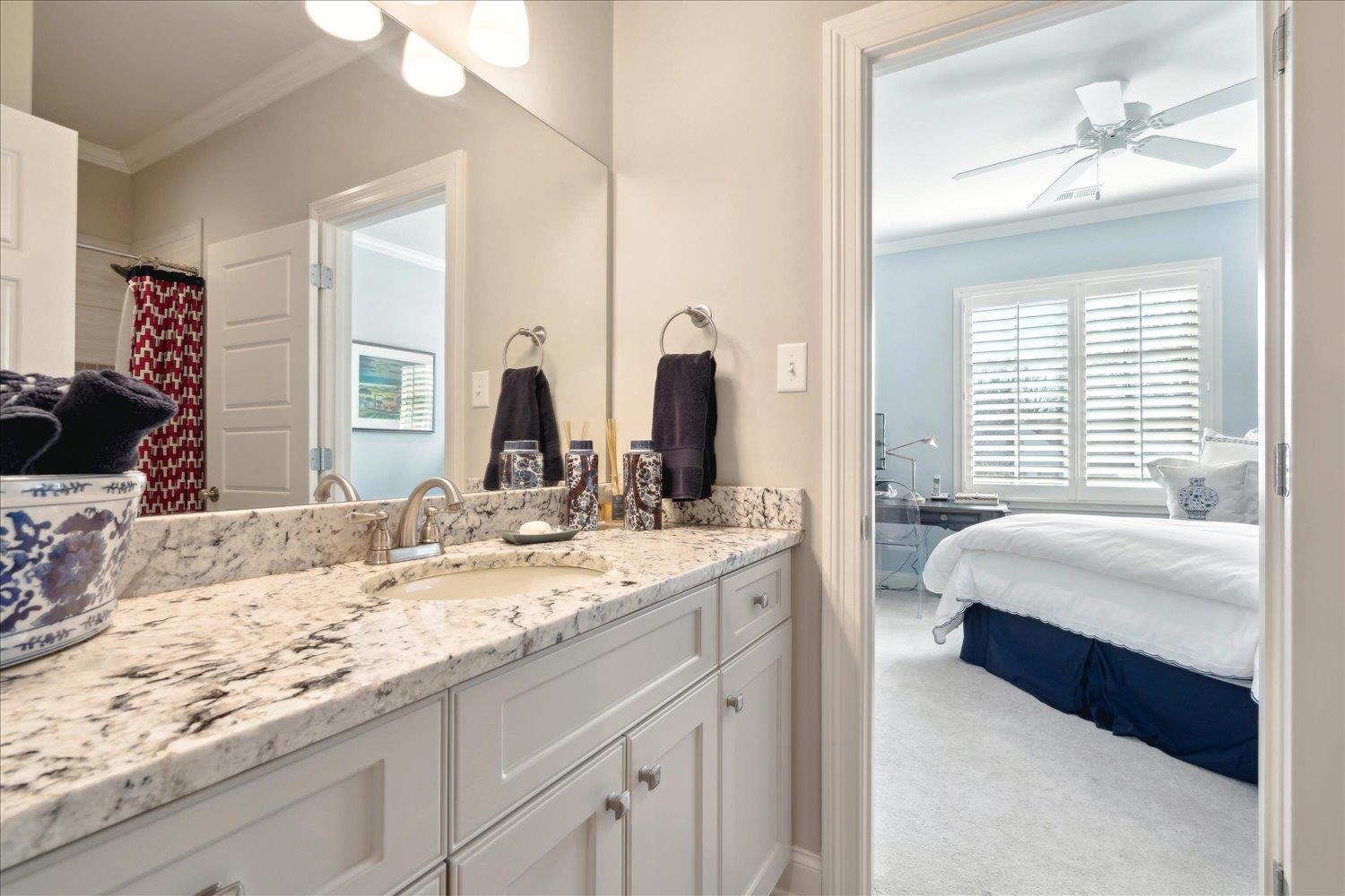 5140 Shady Grove Road Memphis, TN 38117 - Photo 31 of 39 a en suite bathroom with a granite countertop double vanity sink and a mirror