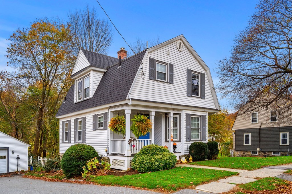 a front view of a house with garden and porch