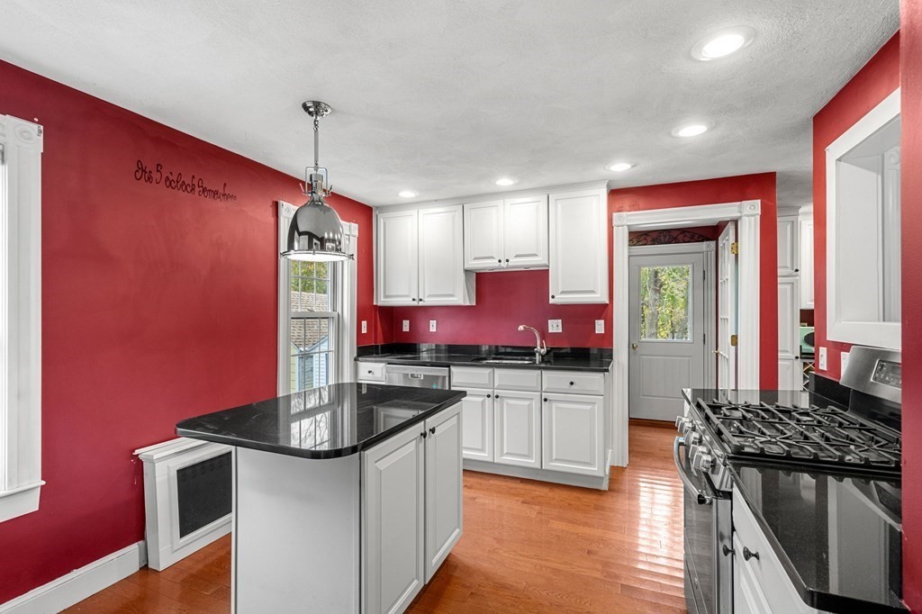 5 Harrison Street Maynard, MA 01754 - Photo 11 of 29 a kitchen with stainless steel appliances granite countertop a stove a sink and a refrigerator