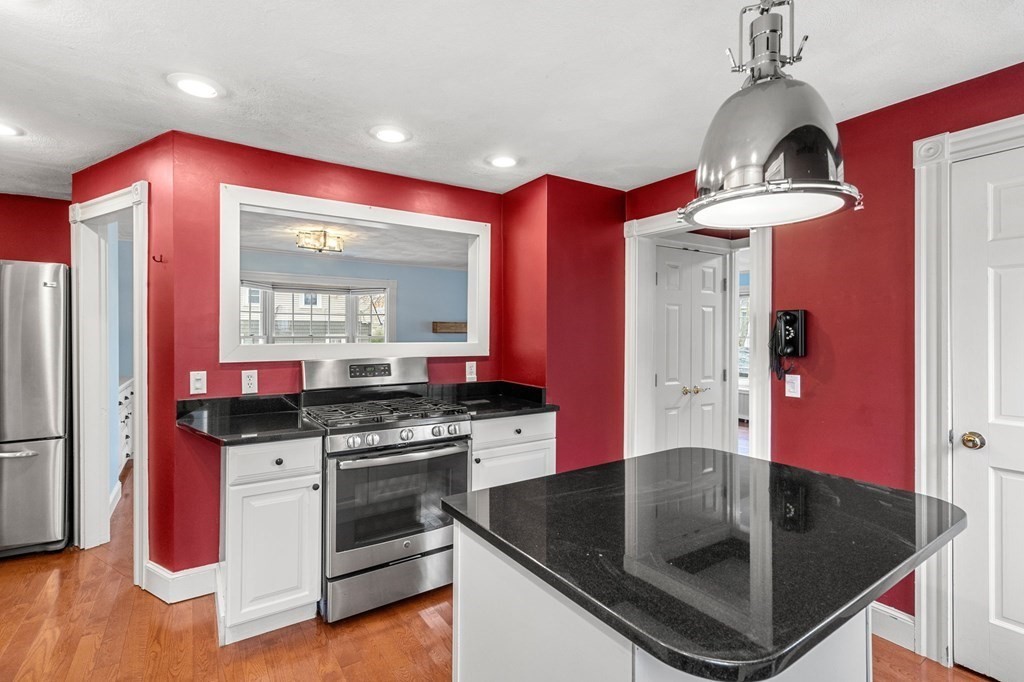 5 Harrison Street Maynard, MA 01754 - Photo 13 of 29 a kitchen with stainless steel appliances granite countertop a stove a refrigerator and a sink