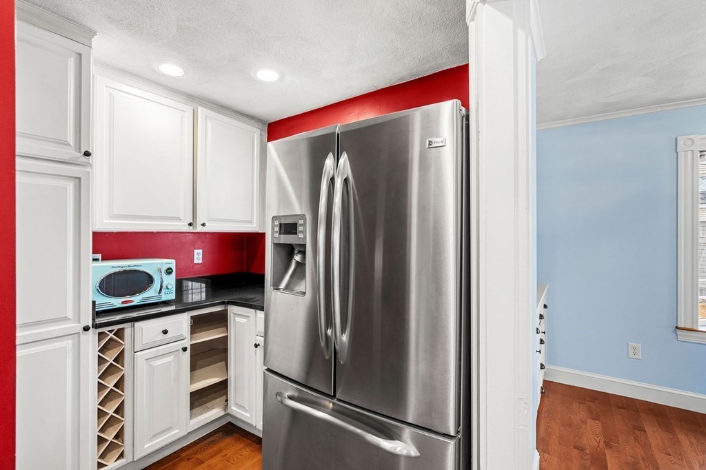 5 Harrison Street Maynard, MA 01754 - Photo 15 of 29 a kitchen with stainless steel appliances granite countertop a refrigerator and a stove top oven