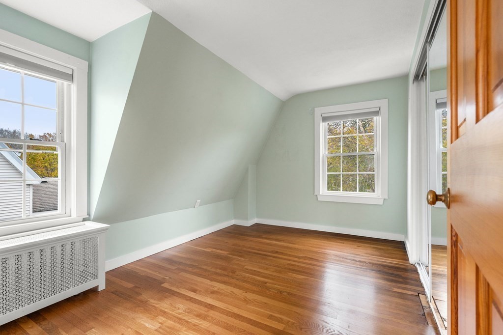 5 Harrison Street Maynard, MA 01754 - Photo 16 of 29 an empty room with wooden floor and windows