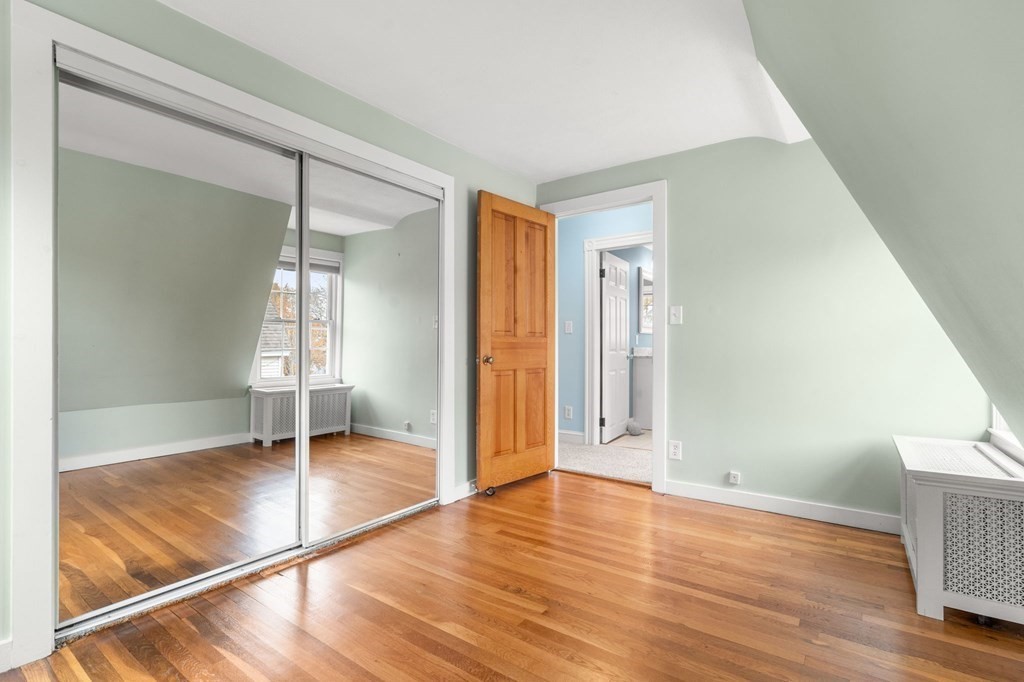 5 Harrison Street Maynard, MA 01754 - Photo 17 of 29 a view of empty room with wooden floor and fan