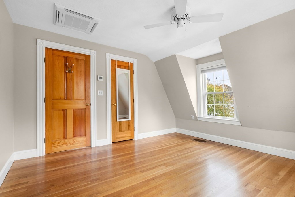 5 Harrison Street Maynard, MA 01754 - Photo 20 of 29 an empty room with wooden floor and windows