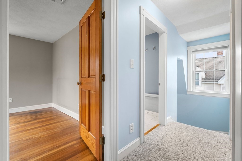 5 Harrison Street Maynard, MA 01754 - Photo 21 of 29 a view of a room with wooden floor and a bathroom