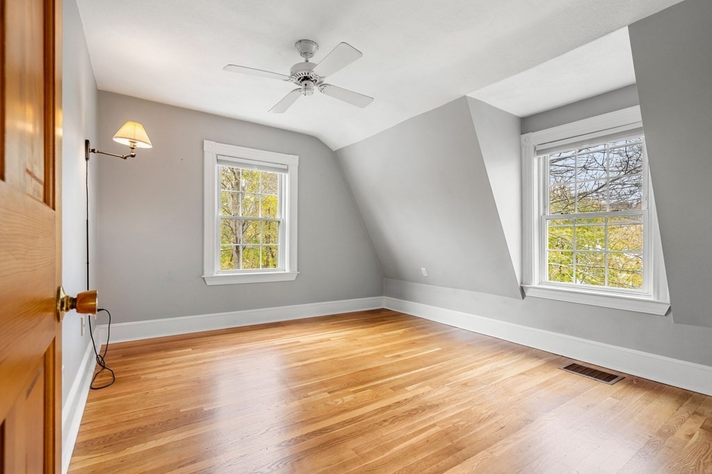 5 Harrison Street Maynard, MA 01754 - Photo 22 of 29 a view of an empty room with a window and wooden floor