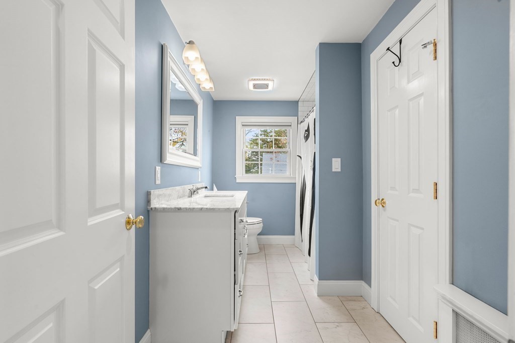 5 Harrison Street Maynard, MA 01754 - Photo 24 of 29 a bathroom with a sink a toilet and a mirror