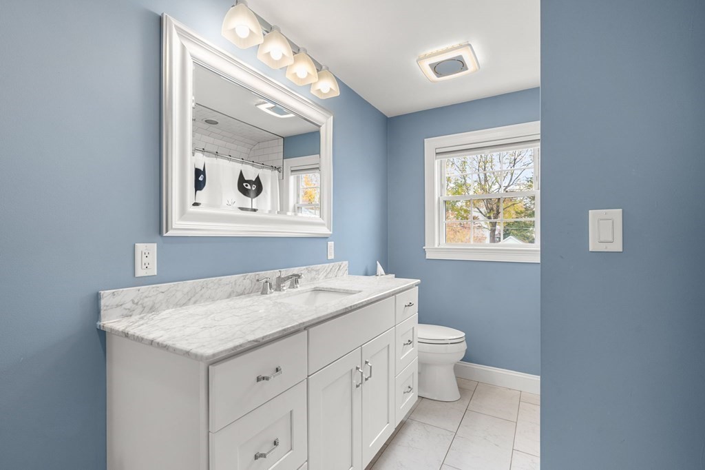 5 Harrison Street Maynard, MA 01754 - Photo 25 of 29 a bathroom with a granite countertop sink toilet and mirror