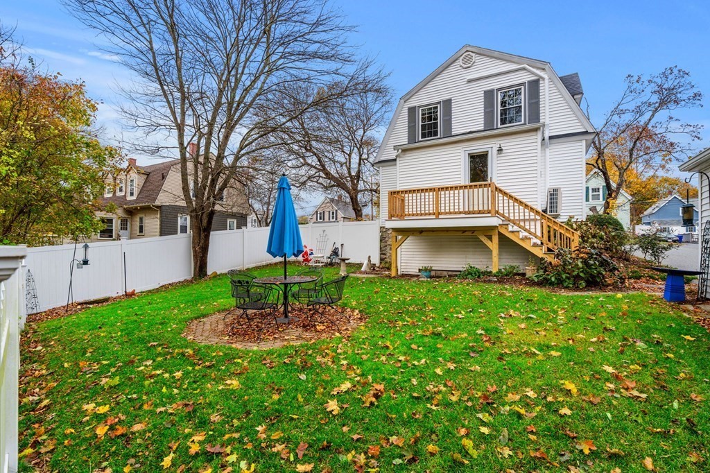 5 Harrison Street Maynard, MA 01754 - Photo 26 of 29 a backyard of a house with plants and large tree