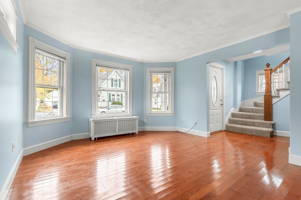 5 Harrison Street Maynard, MA 01754 - Photo 6 of 29 an empty room with wooden floor and windows