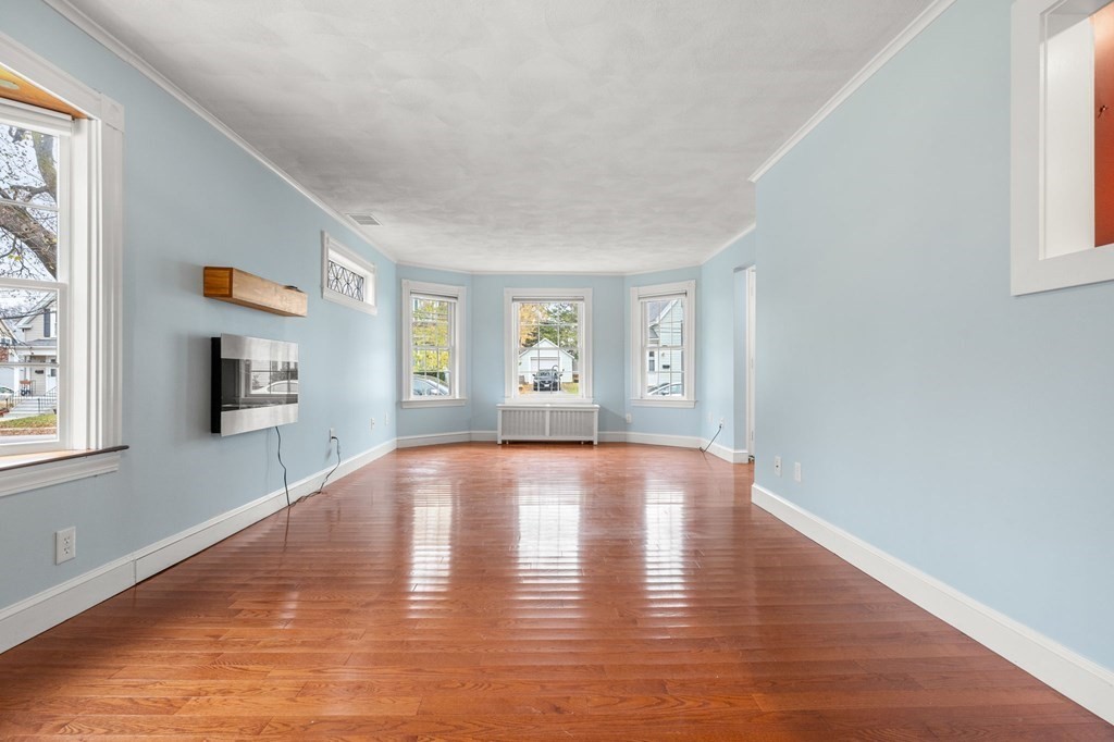 5 Harrison Street Maynard, MA 01754 - Photo 7 of 29 a view of an empty room with a window and wooden floor