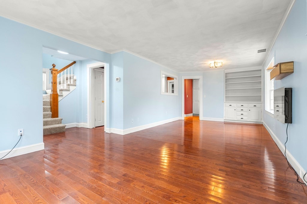 5 Harrison Street Maynard, MA 01754 - Photo 8 of 29 a view of an empty room with wooden floor and a window